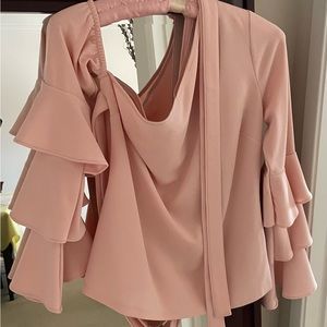 Dusty pink one shoulder long ruffle sleeve top. Wrap belt attached.